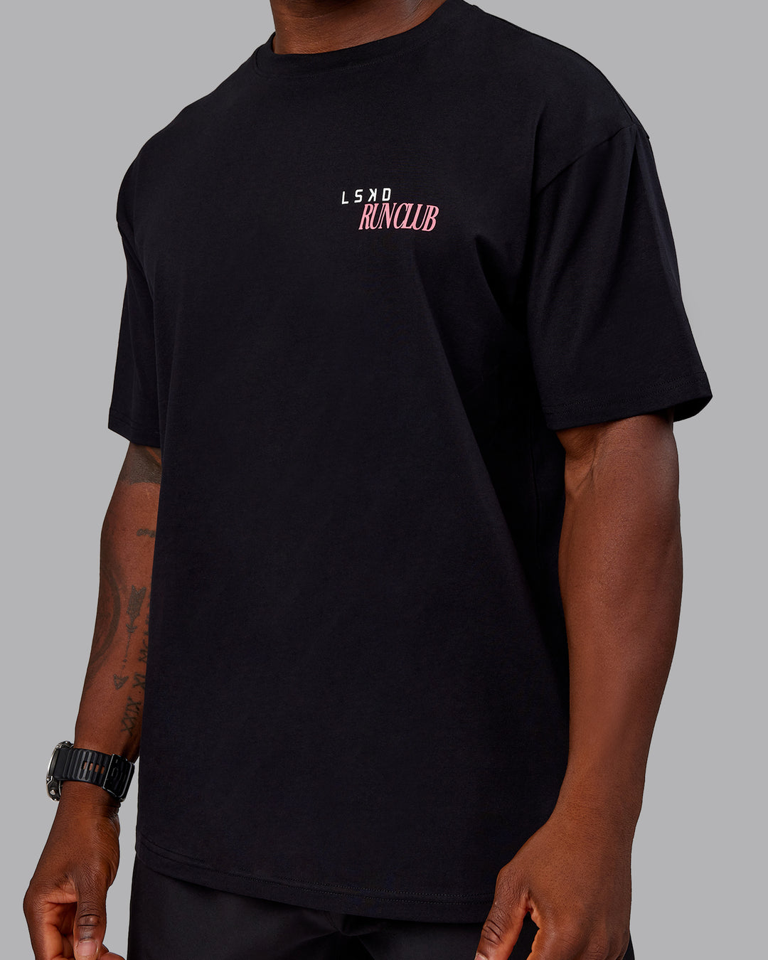 Man wearing Run Love FLXCotton Oversized Tee - Black-Pink Lemonade | Model:Sam | Size:L