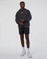 Man wearing Runner’s Unisex Oversized Hoodie - Black Washed-White | Model:Paabio | Size:L