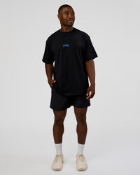 Man wearing Standard Issue FLXCotton Oversized Tee - Black-Palace Blue | Model:Sam | Size:L