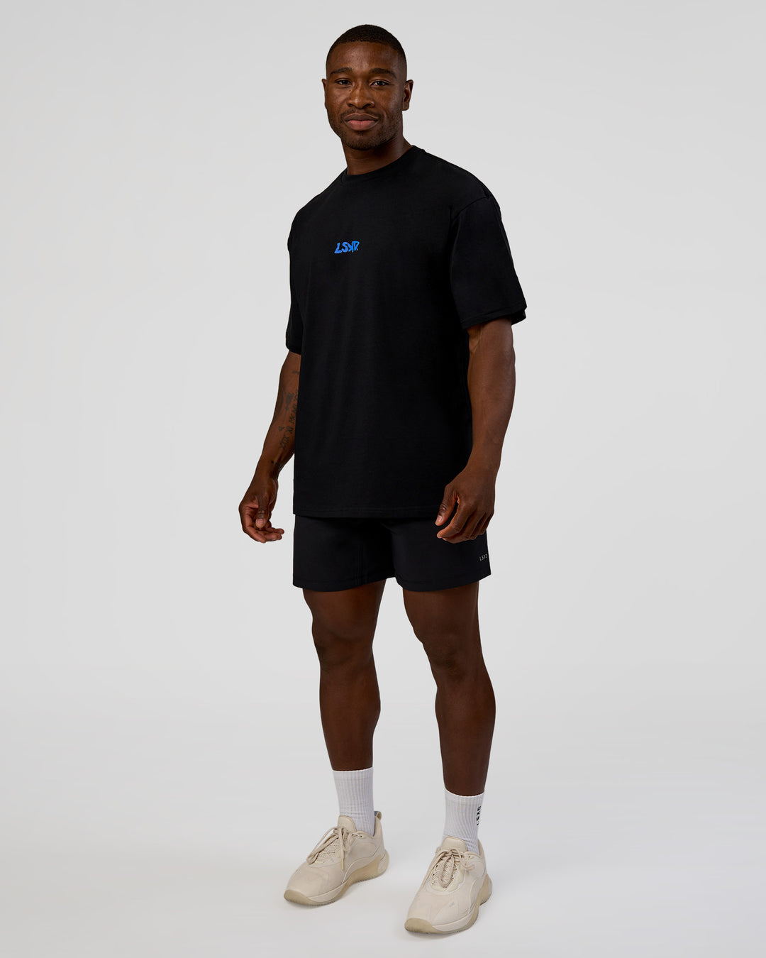 Man wearing Standard Issue FLXCotton Oversized Tee - Black-Palace Blue | Model:Sam | Size:L