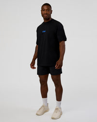 Man wearing Standard Issue FLXCotton Oversized Tee - Black-Palace Blue | Model:Sam | Size:L