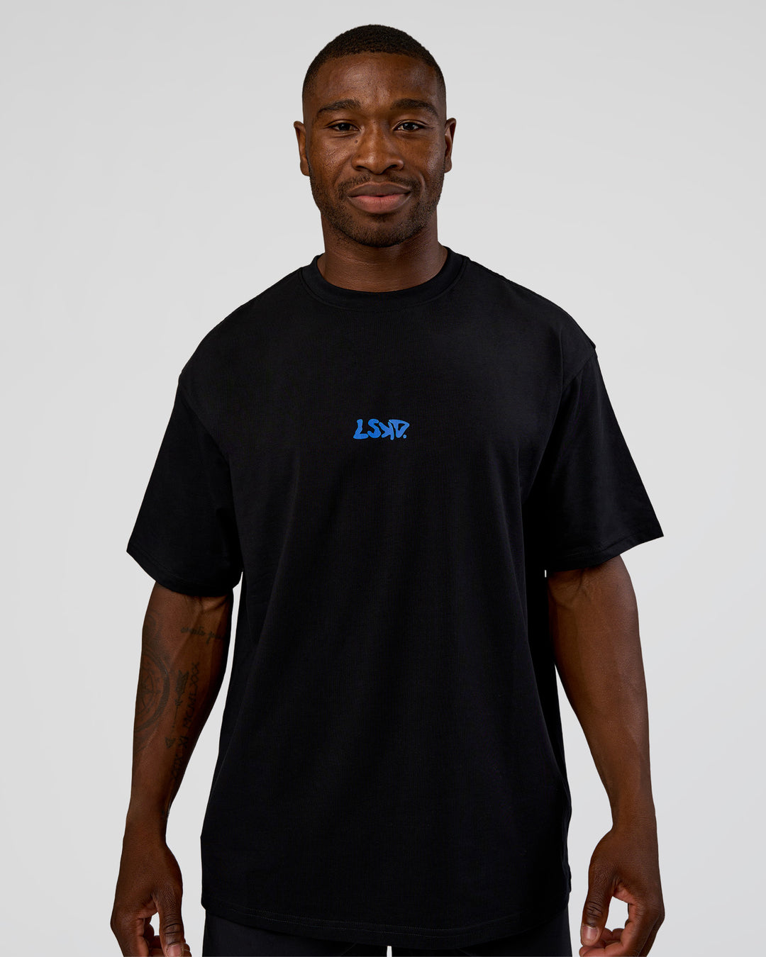 Man wearing Standard Issue FLXCotton Oversized Tee - Black-Palace Blue | Model:Sam | Size:L