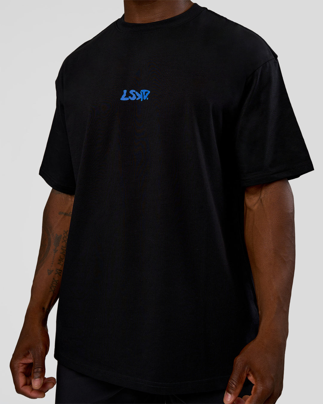 Man wearing Standard Issue FLXCotton Oversized Tee - Black-Palace Blue | Model:Sam | Size:L