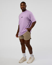 Man wearing Standard Issue FLXCotton Oversized Tee - Pale Lilac-Black | Model:Sam | Size:L