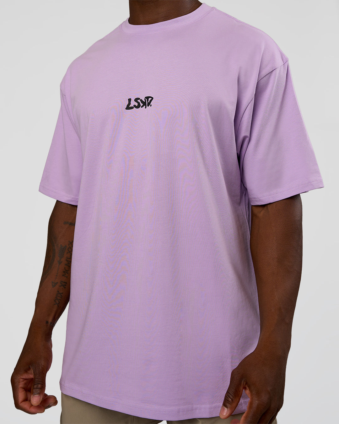 Man wearing Standard Issue FLXCotton Oversized Tee - Pale Lilac-Black | Model:Sam | Size:L
