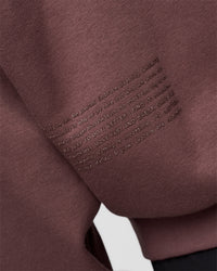 Man wearing Static Grit Unisex Boxy Hoodie - Cocoa Powder-Hot Chocolate | Model:Jackson | Size:L