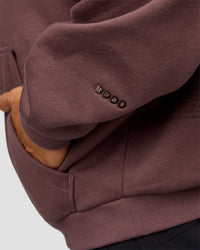 Man wearing Static Grit Unisex Boxy Hoodie - Cocoa Powder-Hot Chocolate | Model:Jackson | Size:L