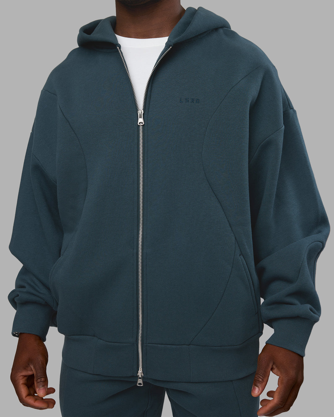 Man wearing Stream Oversized Panel Zip Hoodie - Deep Sea | Model:Sam | Size:L