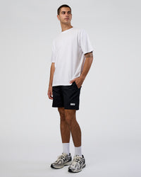Man wearing Together We Rise FLXCotton Oversized Tee - White-Solar Lime | Model:Zoran | Size:L