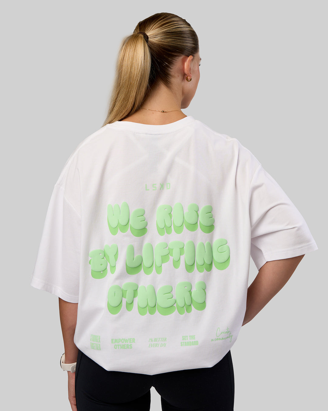 Woman wearing Together We Rise FLXCotton Oversized Tee - White-Solar Lime | Model:Myrte | Size:L