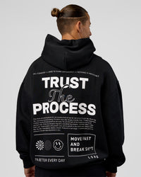 Man wearing Trust The Process Unisex Oversized Hoodie - Black-White | Model:Jaiden | Size:L