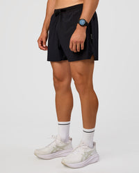 Man wearing UltraAir 5" Lined Performance Short  - Black-Reflective | Model:Liam | Size:L