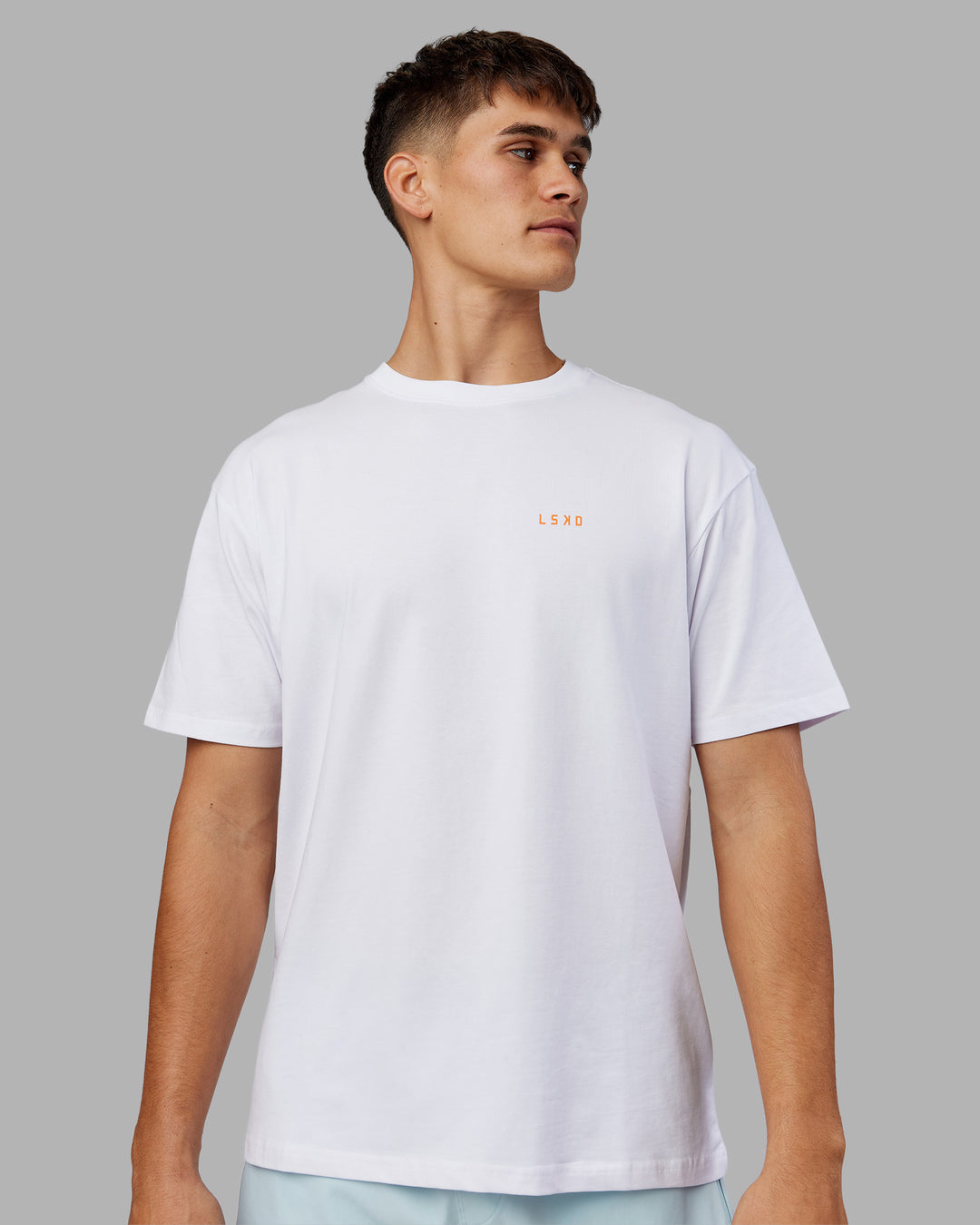 Man wearing Enjoy the Journey Value Series FLXCotton Tee Oversize - White-Vibrant Orange | Model:Jackson | Size:L