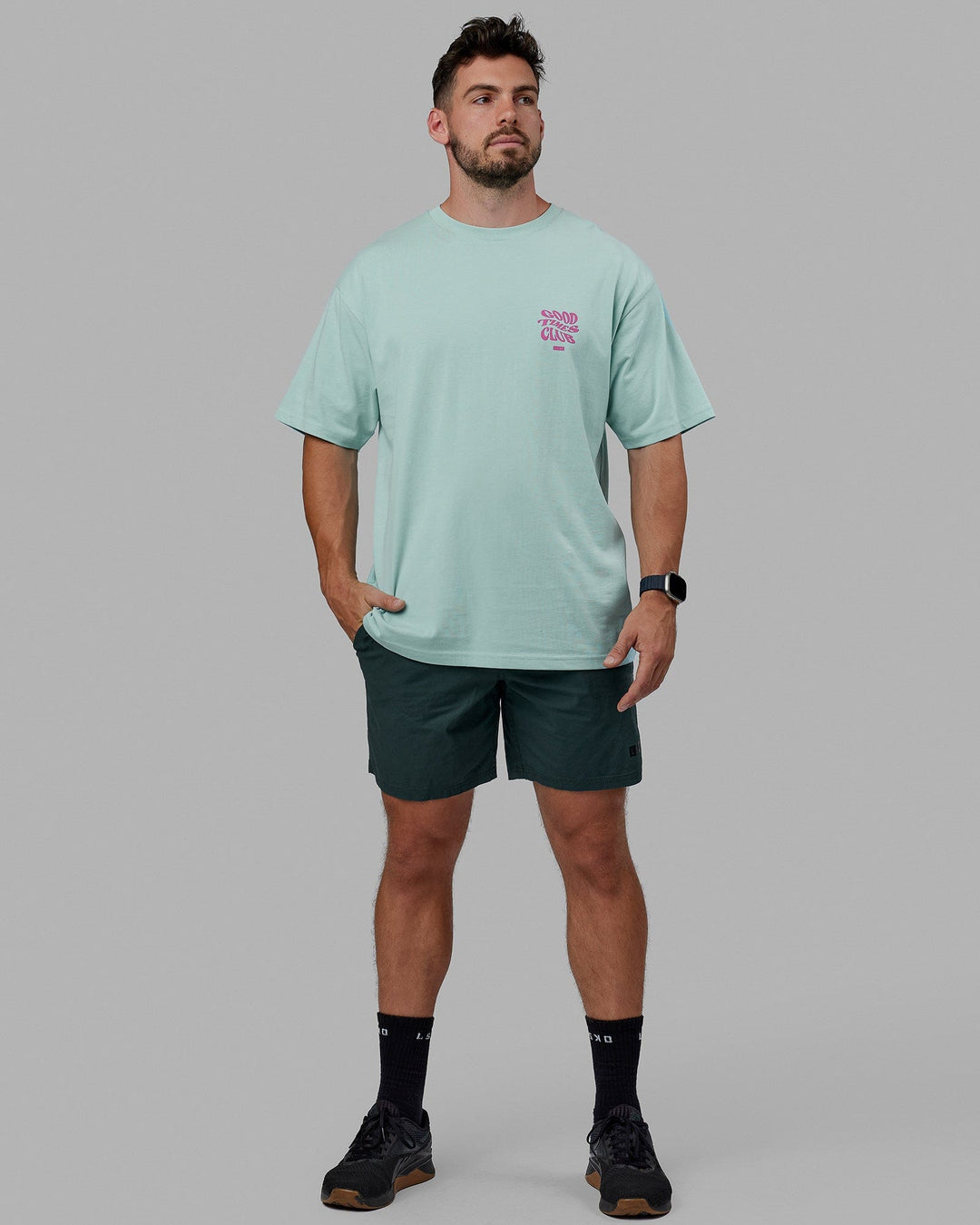 Man wearing Unisex Good Times Heavyweight Tee Oversize - Pastel Turquoise-Spark Pink