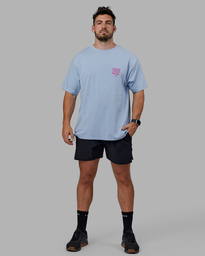 Man wearing Unisex Good Times Heavyweight Tee Oversize - Windsurfer-Spark Pink