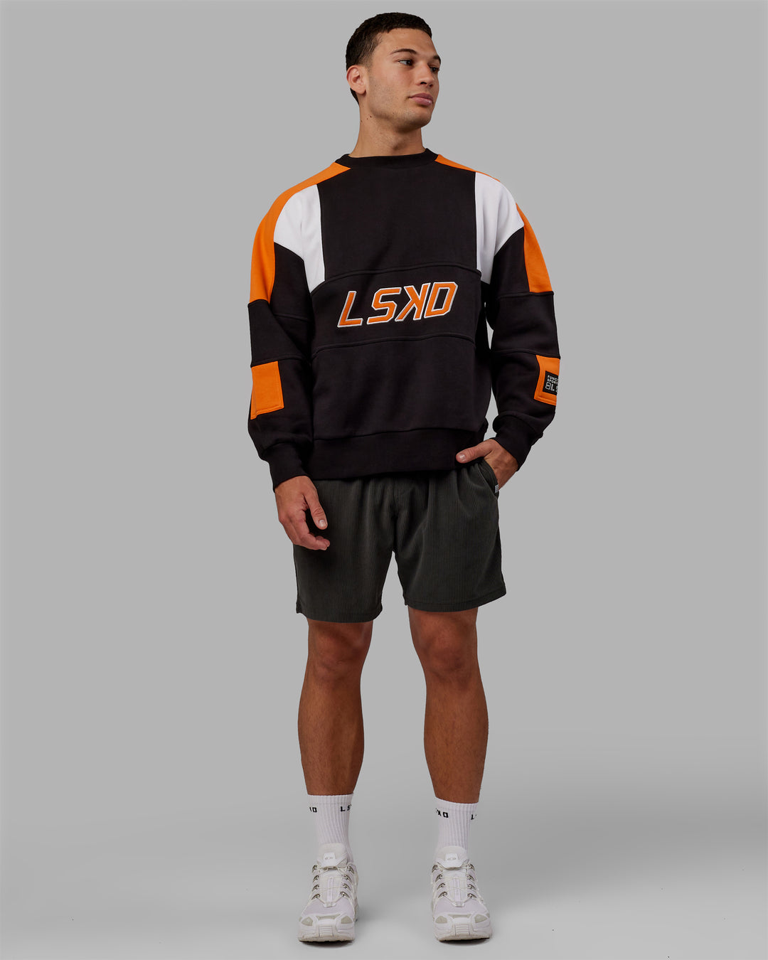 Man wearing Unisex Slam Sweater Oversize - Black-Ultra Orange