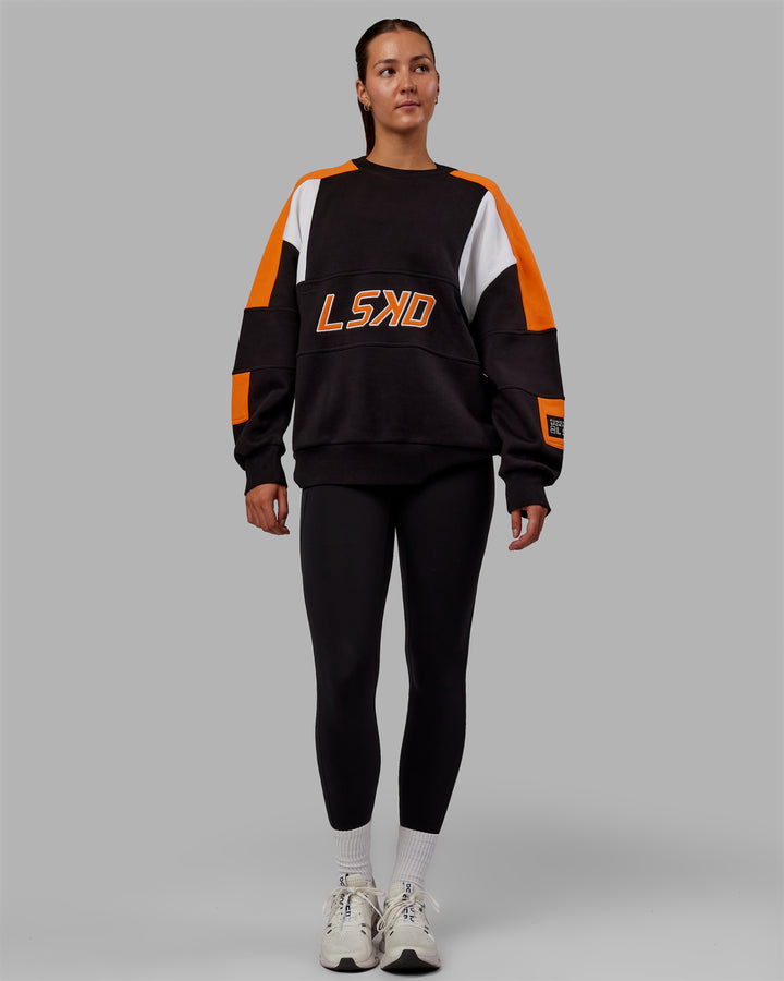 Woman wearing Unisex Slam Sweater Oversize - Black-Ultra Orange