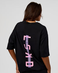 Woman wearing Unisex Strike Through FLXCotton Tee Oversize - Black-Candy Pink | Model:Kirstyn | Size:L