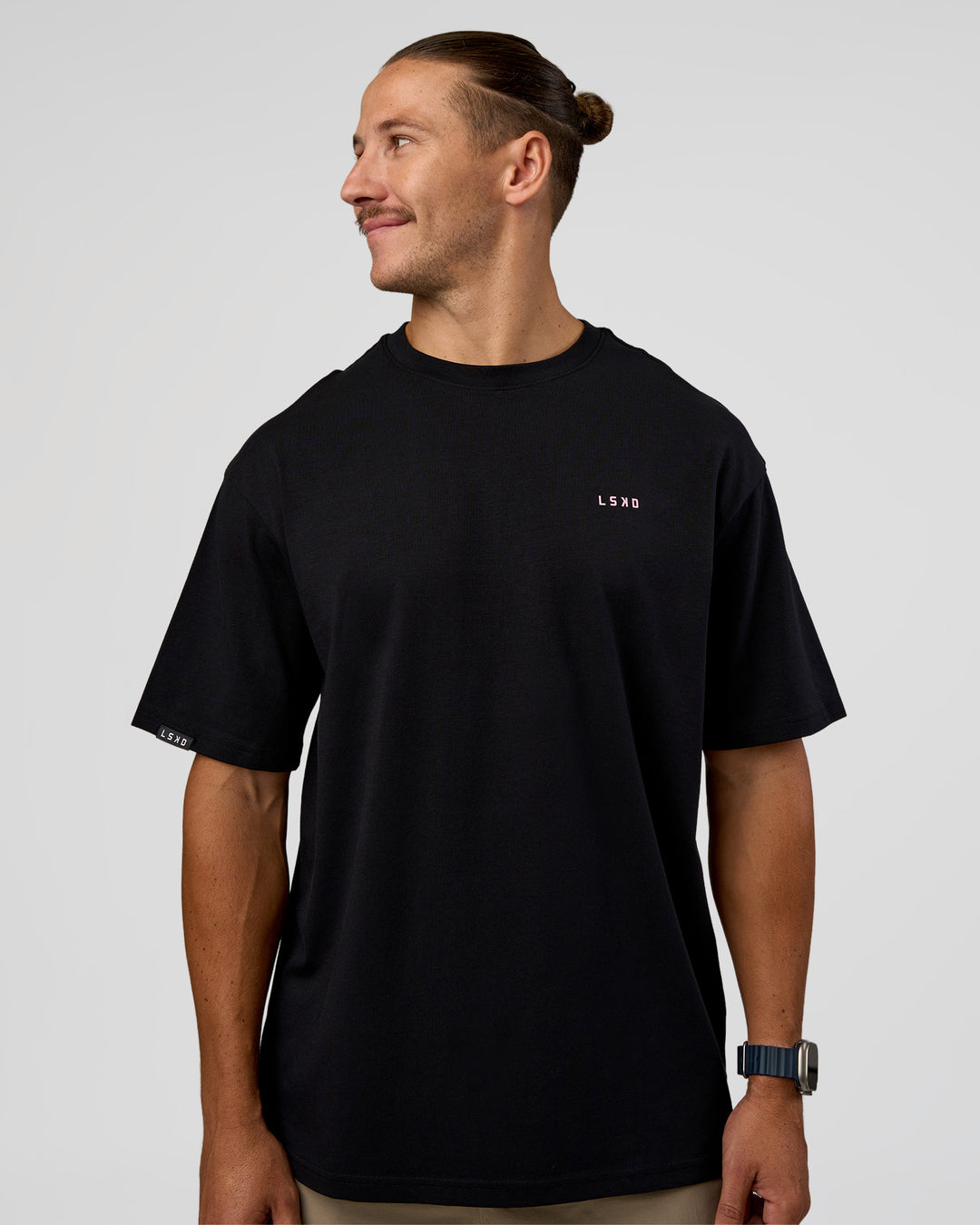 Man wearing Unisex Strike Through FLXCotton Tee Oversize - Black-Candy Pink | Model:Jaiden | Size:L