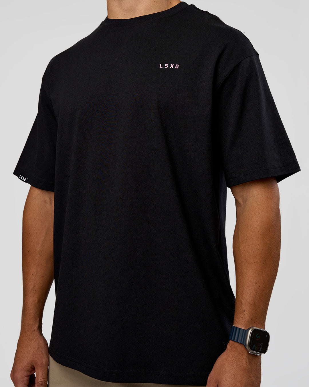 Man wearing Unisex Strike Through FLXCotton Tee Oversize - Black-Candy Pink | Model:Jaiden | Size:L