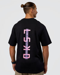 Man wearing Unisex Strike Through FLXCotton Tee Oversize - Black-Candy Pink | Model:Jaiden | Size:L
