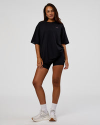 Woman wearing Unisex Strike Through FLXCotton Tee Oversize - Black-Candy Pink | Model:Kirstyn | Size:L
