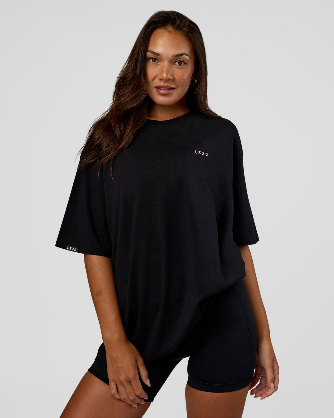 Woman wearing Unisex Strike Through FLXCotton Tee Oversize - Black-Candy Pink | Model:Kirstyn | Size:L