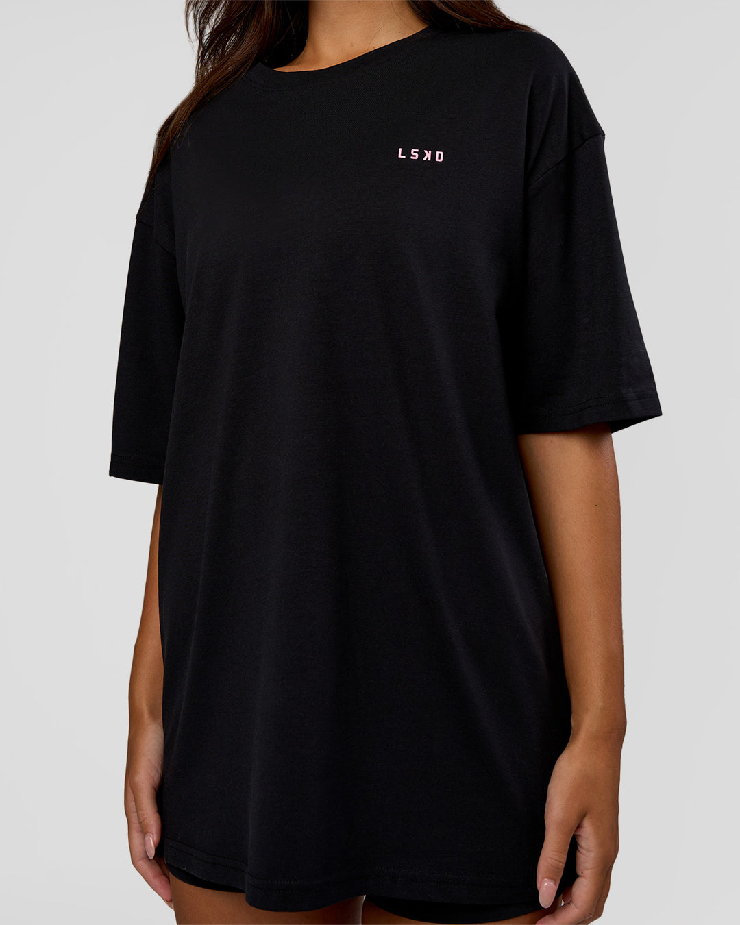 Woman wearing Unisex Strike Through FLXCotton Tee Oversize - Black-Candy Pink | Model:Kirstyn | Size:L