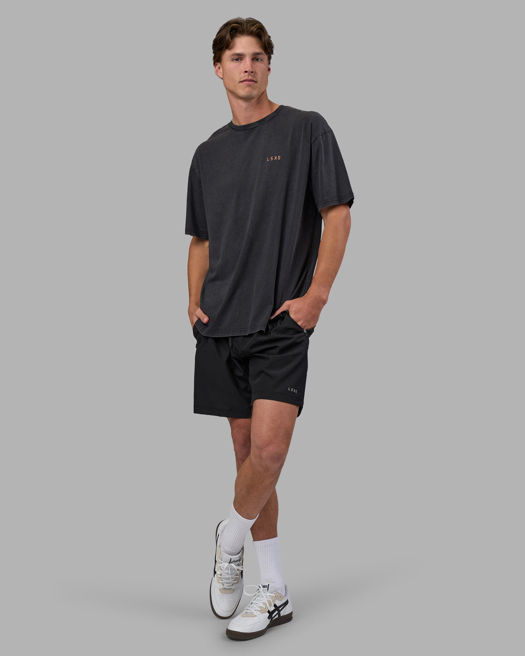 Man wearing Unisex Strike Through FLXCotton Tee Oversize - Black Washed-Cantaloupe | Model:Brandon | Size:L