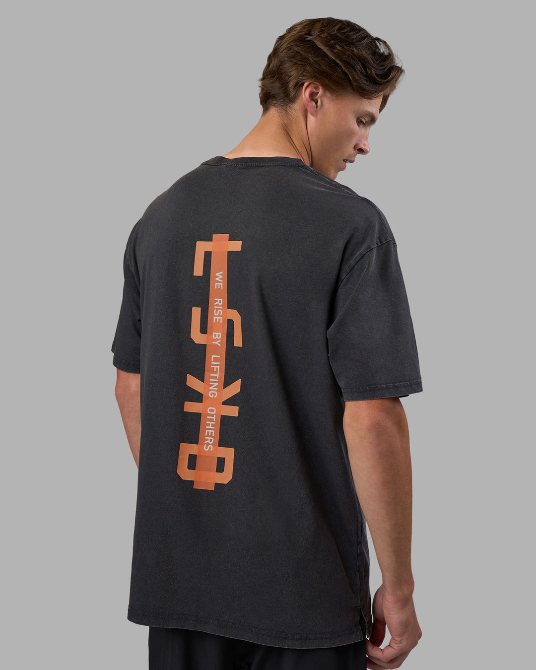 Man wearing Unisex Strike Through FLXCotton Tee Oversize - Black Washed-Cantaloupe | Model:Brandon | Size:L