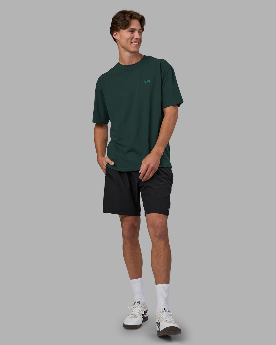 Man wearing Unisex Strike Through FLXCotton Tee Oversize - Vital Green-Alexandrite | Model:Brandon | Size:L