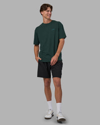 Man wearing Unisex Strike Through FLXCotton Tee Oversize - Vital Green-Alexandrite | Model:Brandon | Size:L