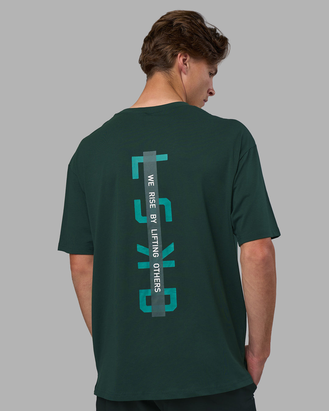 Man wearing Unisex Strike Through FLXCotton Tee Oversize - Vital Green-Alexandrite | Model:Brandon | Size:L