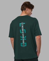 Man wearing Unisex Strike Through FLXCotton Tee Oversize - Vital Green-Alexandrite | Model:Brandon | Size:L