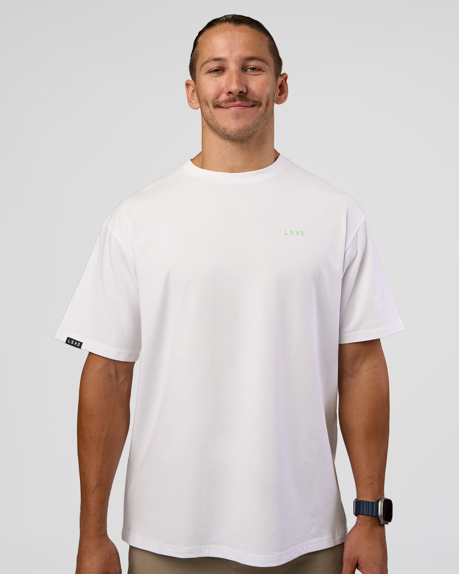 Man wearing Unisex Strike Through FLXCotton Tee Oversize - White-Warm Apricot | Model:Jaiden | Size:L