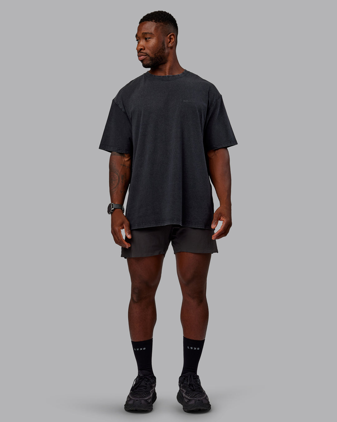 Man wearing Unisex Washed RUN CLUB FLXCotton Tee Oversize - Black-Black