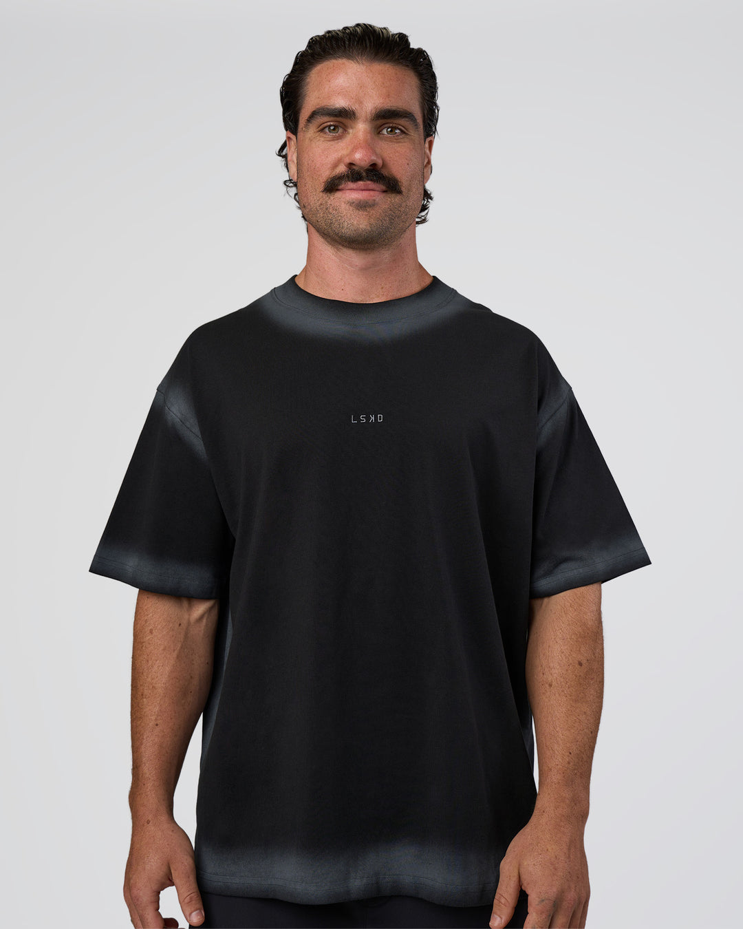 Man wearing Urban Blur Heavyweight Unisex Oversized Tee - Black-Dark Storm | Model:Adam | Size:L