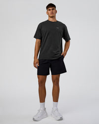 Man wearing We Love This  FLXCotton Oversized Tee - Black Washed-White | Model:Jackson | Size:L