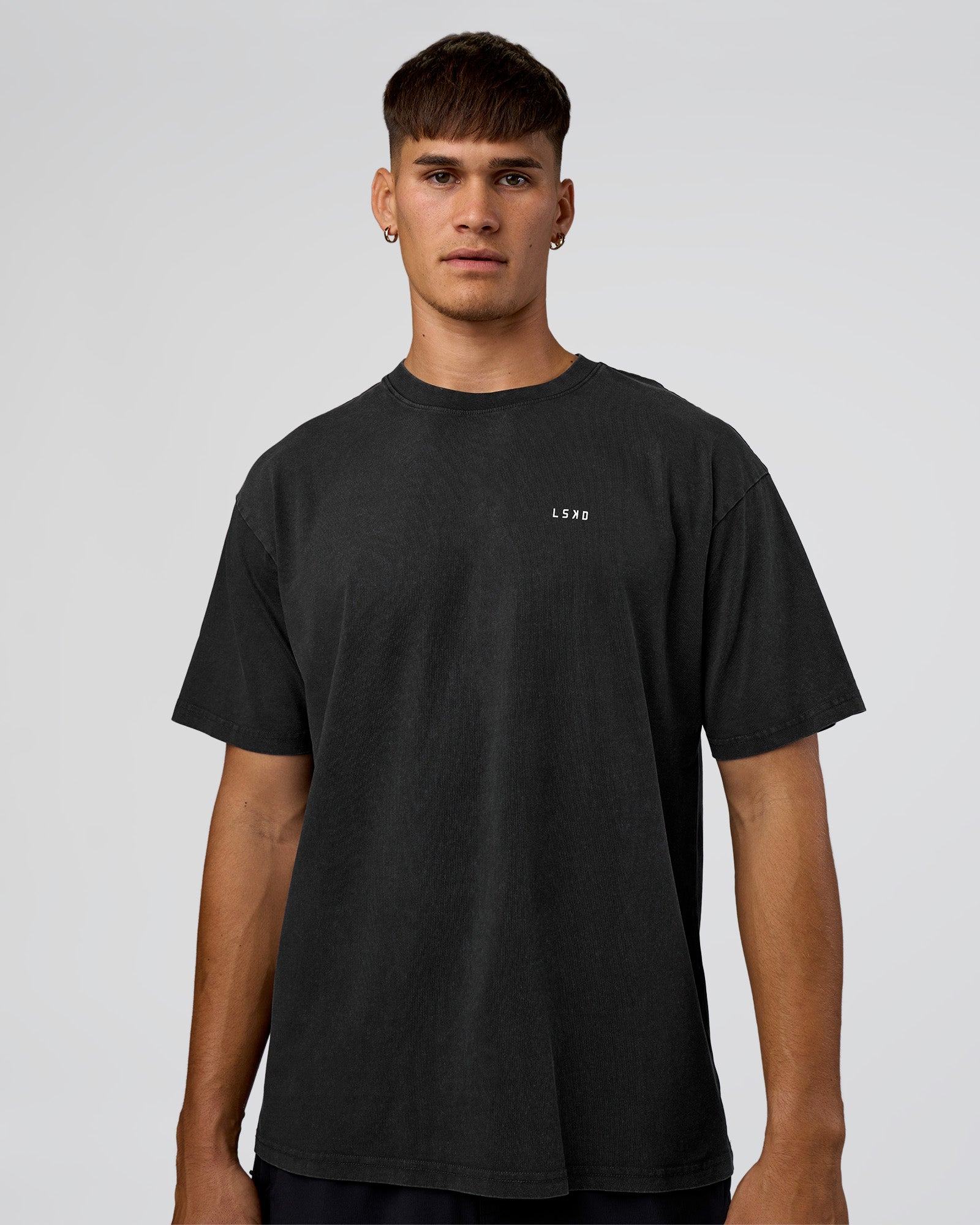 Man wearing We Love This  FLXCotton Oversized Tee - Black Washed-White | Model:Jackson | Size:L