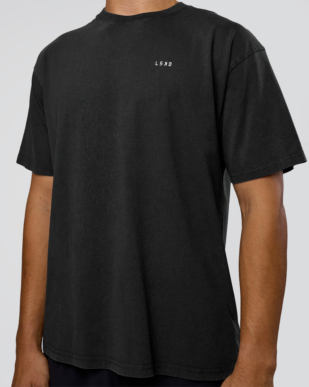 Man wearing We Love This  FLXCotton Oversized Tee - Black Washed-White | Model:Jackson | Size:L