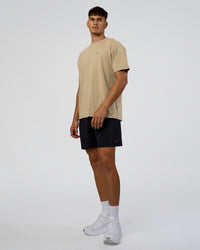Man wearing We Love This  FLXCotton Oversized Tee - Greige Washed-Black | Model:Jackson | Size:L