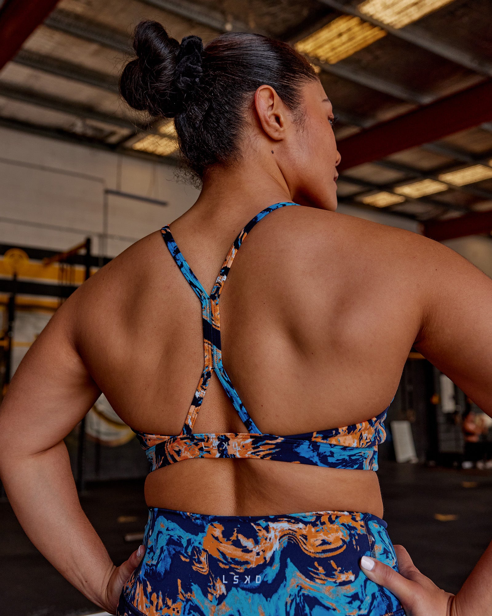 Woman wearing AMRAP High Neck Sports Bra - React Print | Model:Vana | Size:M