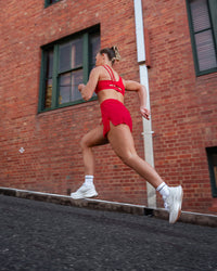Woman wearing Accelerate 3" High-Rise Running Short - Scarlet | Model:Trista | Size:M