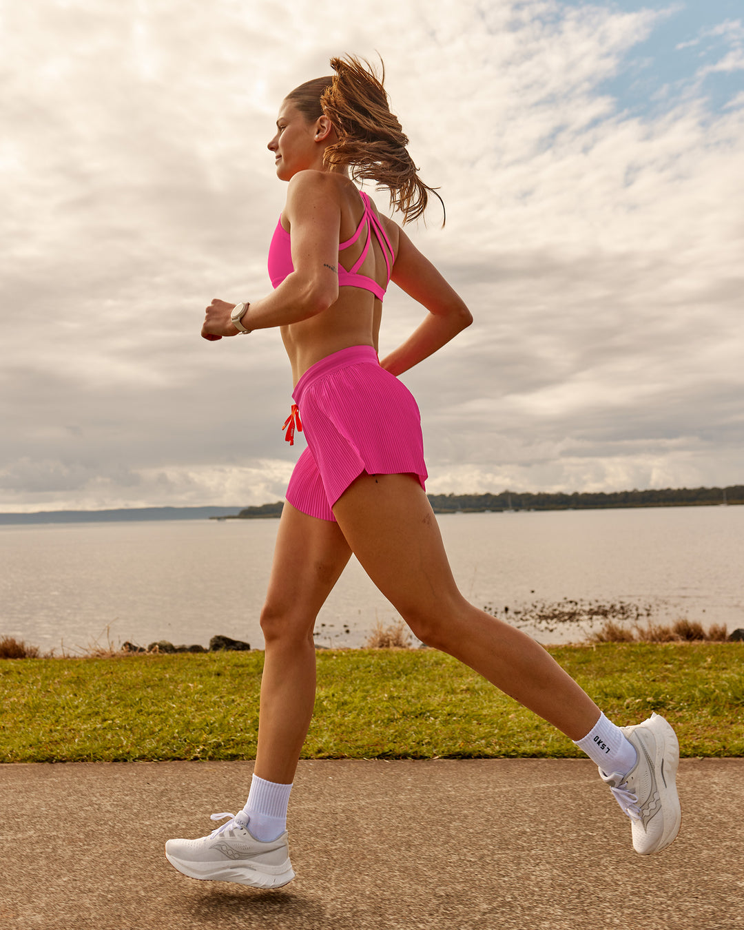 Woman wearing Accelerate 3&quot; Pleated Running Short - Ultra Pink | Model:Phoebe | Size:M