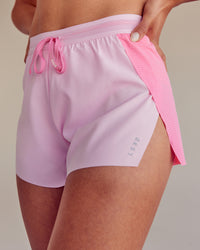 Woman wearing Accelerate 3" High-Rise Running Short - Candy Pink-Marshmallow | Set:true | Angle:closeup | Size:M