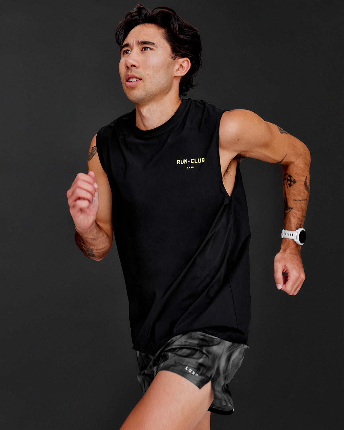 Man wearing Cadence RUN CLUB Muscle Tank - Black-Yellow Fizz | Model:Jared | Size:M