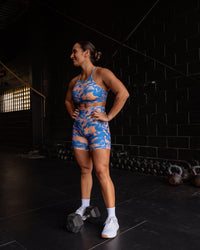 Woman wearing Lift High Neck Sports Bra - Apricot Mist | Model:Tiare | Size:M