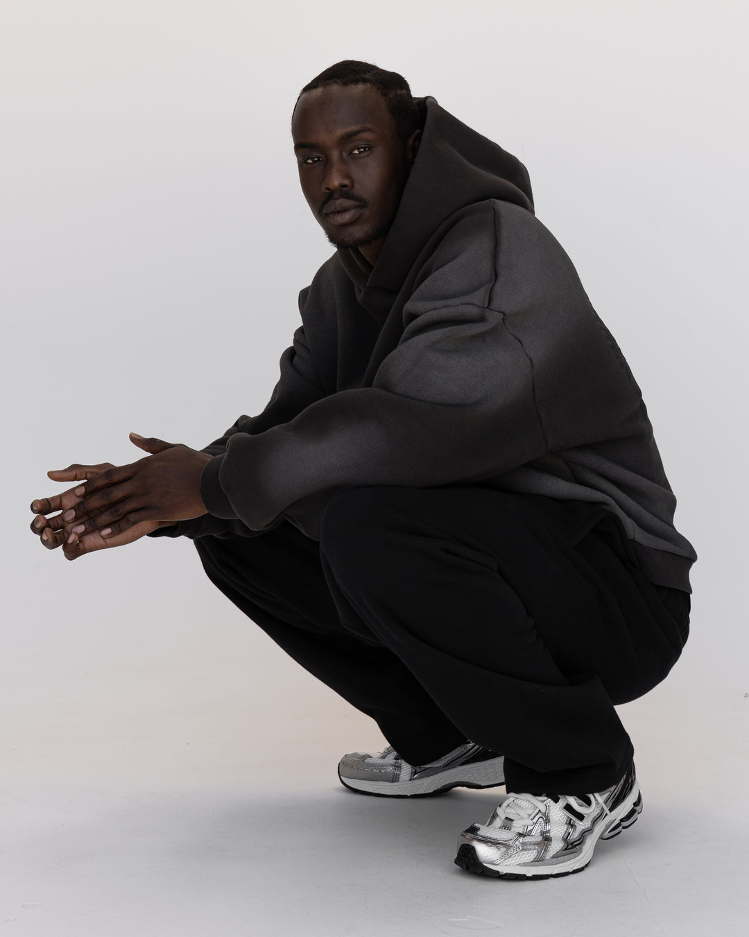 Man wearing Memory In Motion 500gsm Ultra Heavyweight Washed Hoodie - Charcoal Washed | Model:Okello | Size:M