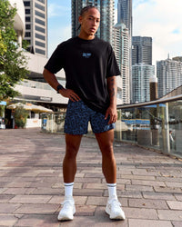 Man wearing Pace 5" Lined Running Short - Energy Print Palace Blue | Model:Malebo | Size:M