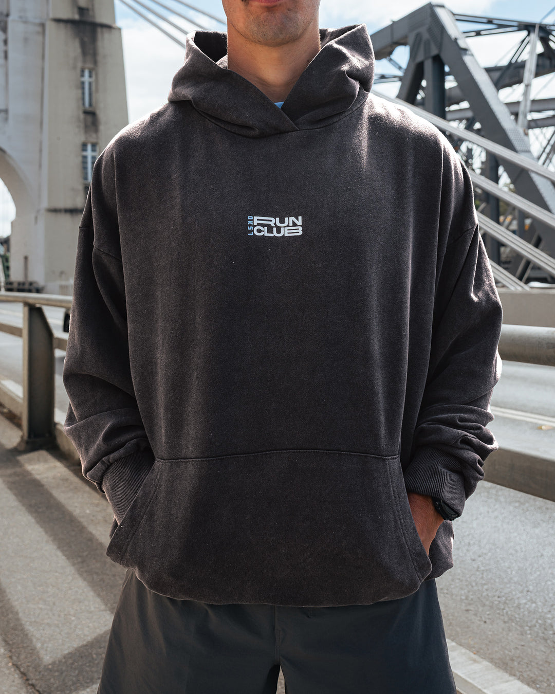 Man wearing Runner’s Unisex Oversized Hoodie - Black Washed-White | Model:Drew | Size:M